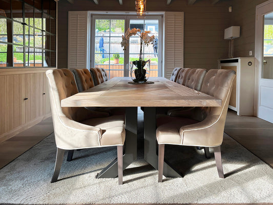 Country classic dining room with an oak herringbone table and tufted linen chairs