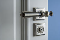 Urbe Door lever handles set on roses in interior - Bronces Mestre