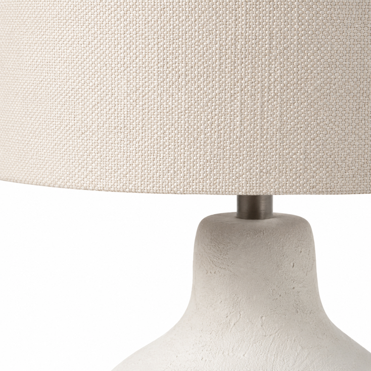 Macro close-up of the Oskar 1916E table lamp revealing the fine fabric weave of the white shade, brushed white sand metal base and subtle textured finish. Detailed craftsmanship from the White Sand collection in a 1xE27 design, by Marcottestyle.