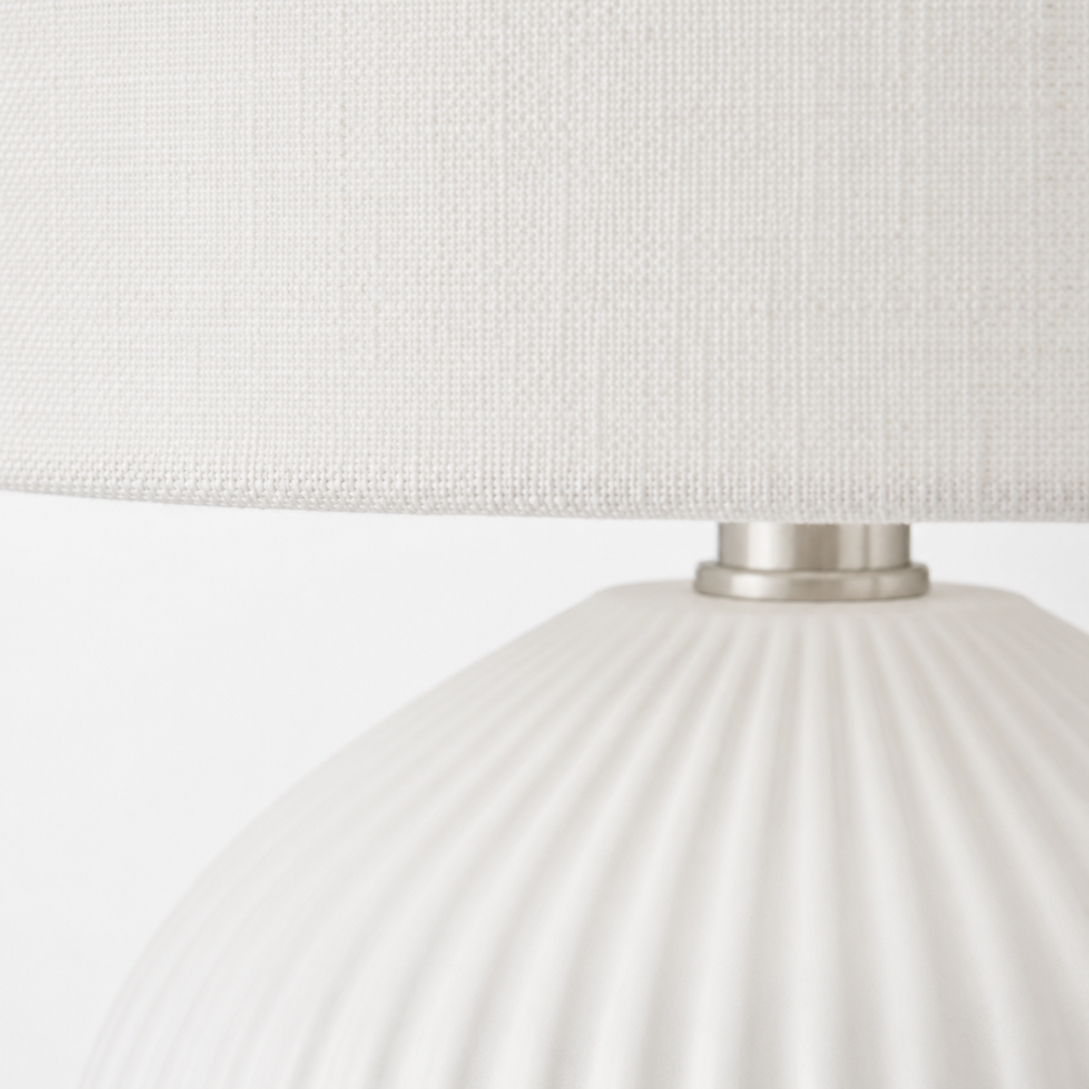Macro close-up of the Zola 4688B table lamp in white, from the Zola family, revealing fine fabric weave on the 40 cm shade and brushed metal base detail, designed for a 1xE27 bulb, contemporary refined style for living and bedroom interiors, by Marcottestyle.