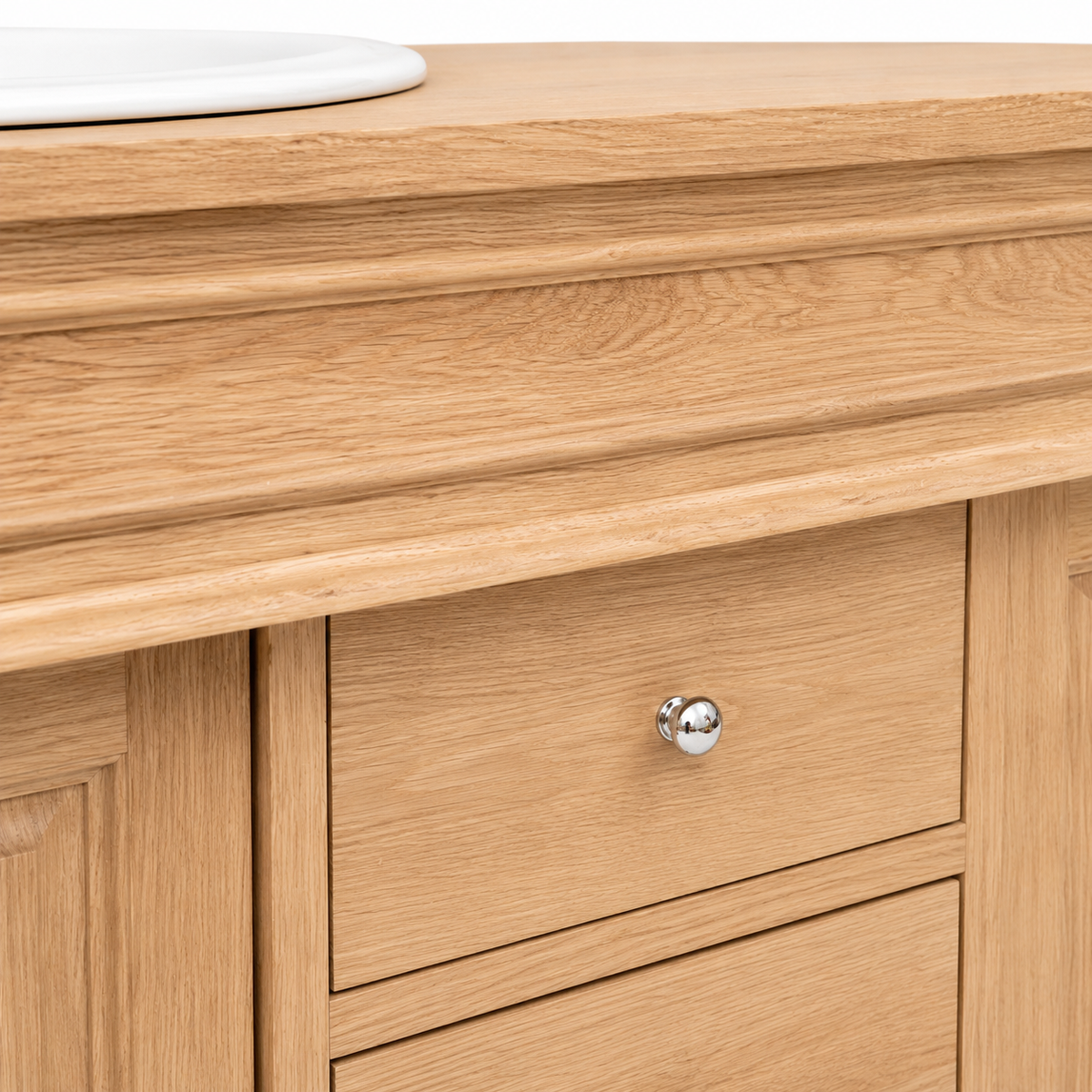 Detail of natural oiled oak grain on the Hartwell vanity countertop edge and chrome knob