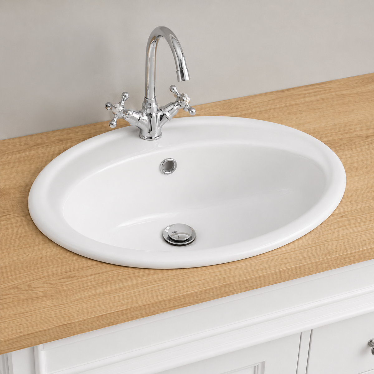 Close-up of inset white ceramic basin with chrome cross-handle tap on oak Hartwell countertop