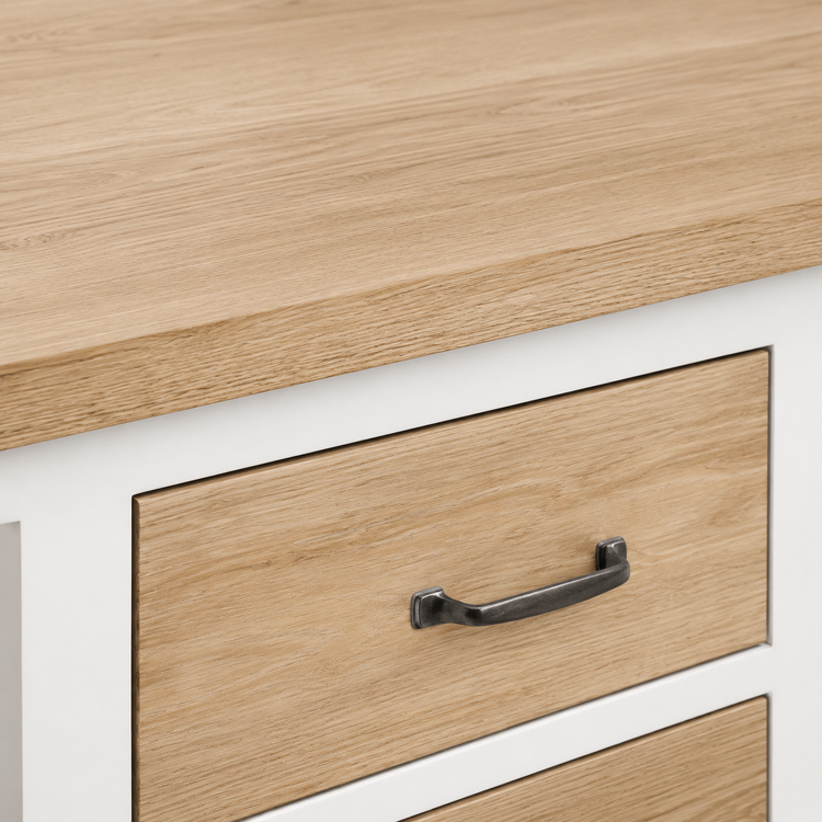 Detail of natural oak drawer front with aged metal handle on the white Seabrook bathroom vanity