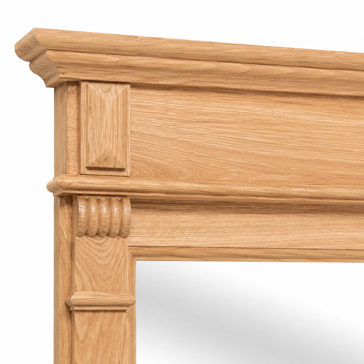 Close-up of the carved oak cornice and corbel detailing on the Baldo bathroom mirror frame