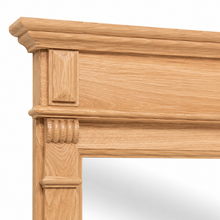 Close-up of the carved oak cornice and corbel detailing on the Baldo bathroom mirror frame