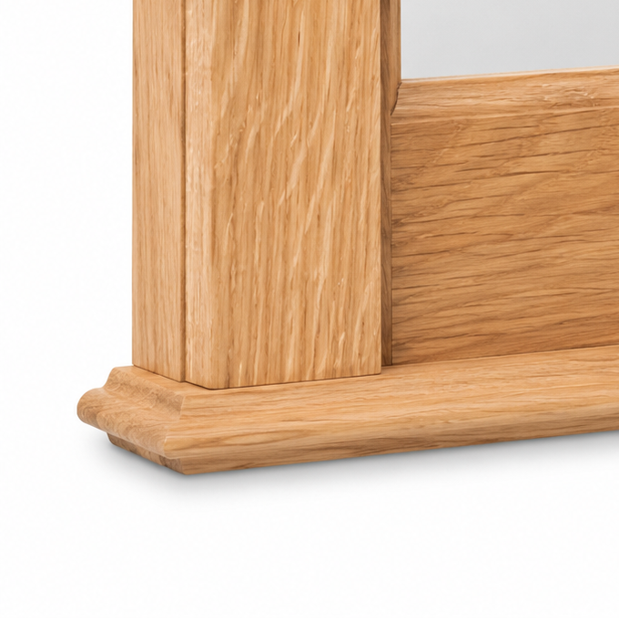 Close-up of the moulded oak base and column foot of the Baldo bathroom mirror frame