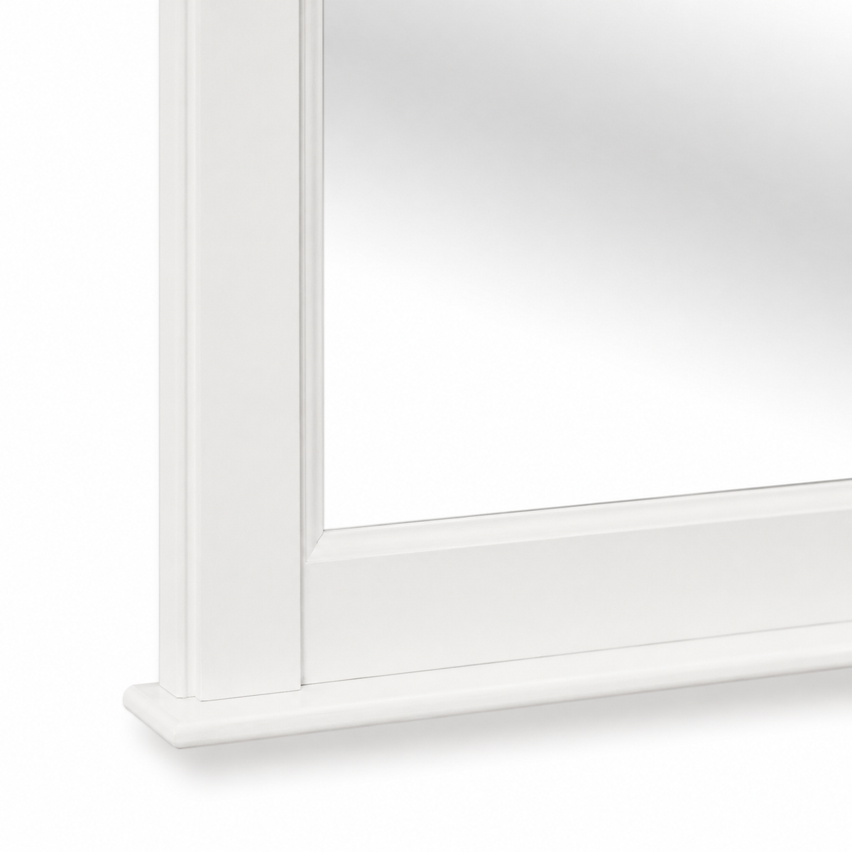 Close-up of the white painted pine Baldo mirror frame corner and base moulding