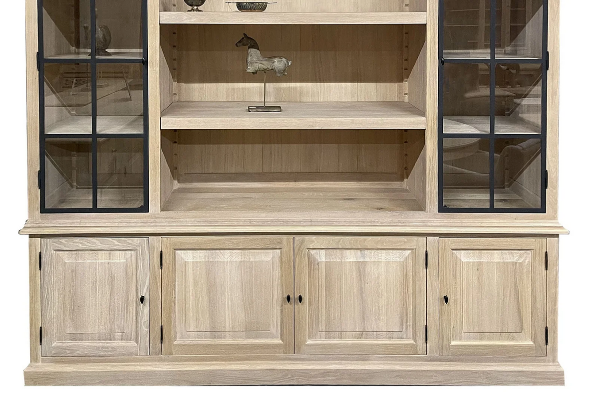 Open central shelving and raised-panel doors of the country-style oak Harrison display cabinet