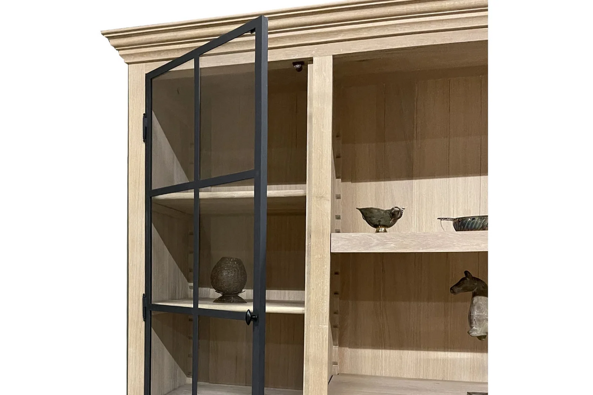 Crown molding and open glazed door atop the country-style oak Harrison display cabinet