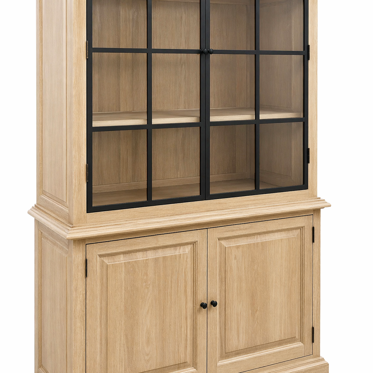Close-up of the Soren cabinet black iron window-pane glass doors above the natural oak panelled base