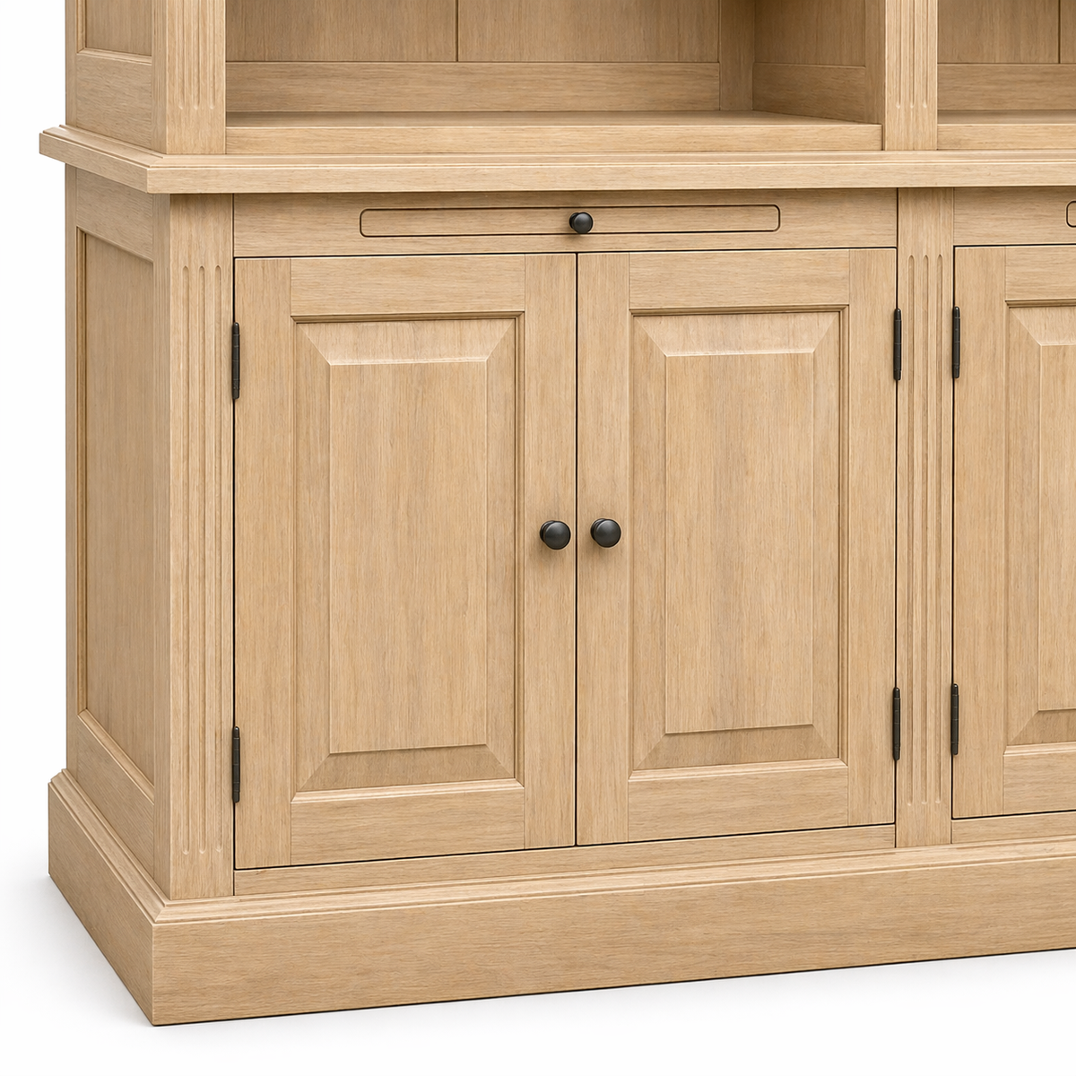 Raised-panel lower cabinet doors with black knobs and pull-out tray on natural oak Milton library cabinet