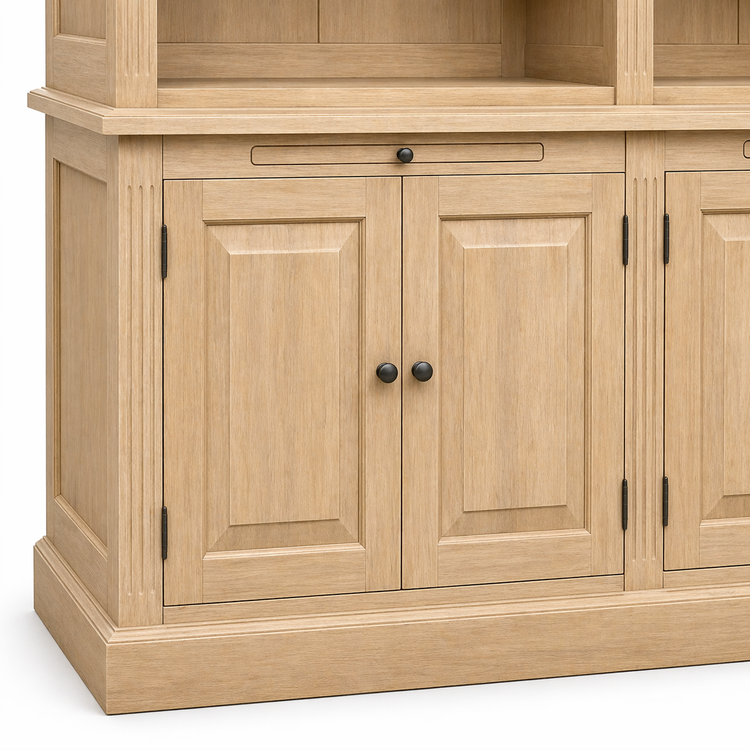 Raised-panel lower cabinet doors with black knobs and pull-out tray on natural oak Milton library cabinet