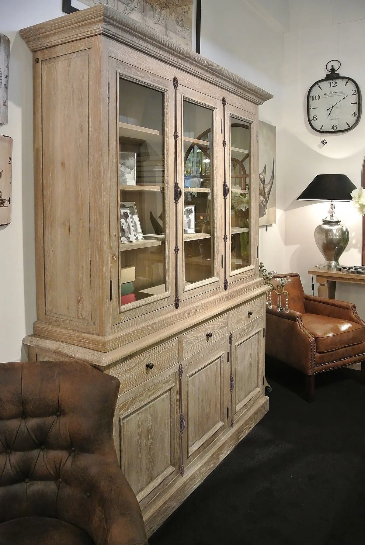 Country-style weathered oak Olon display cabinet styled with decor in a living room setting