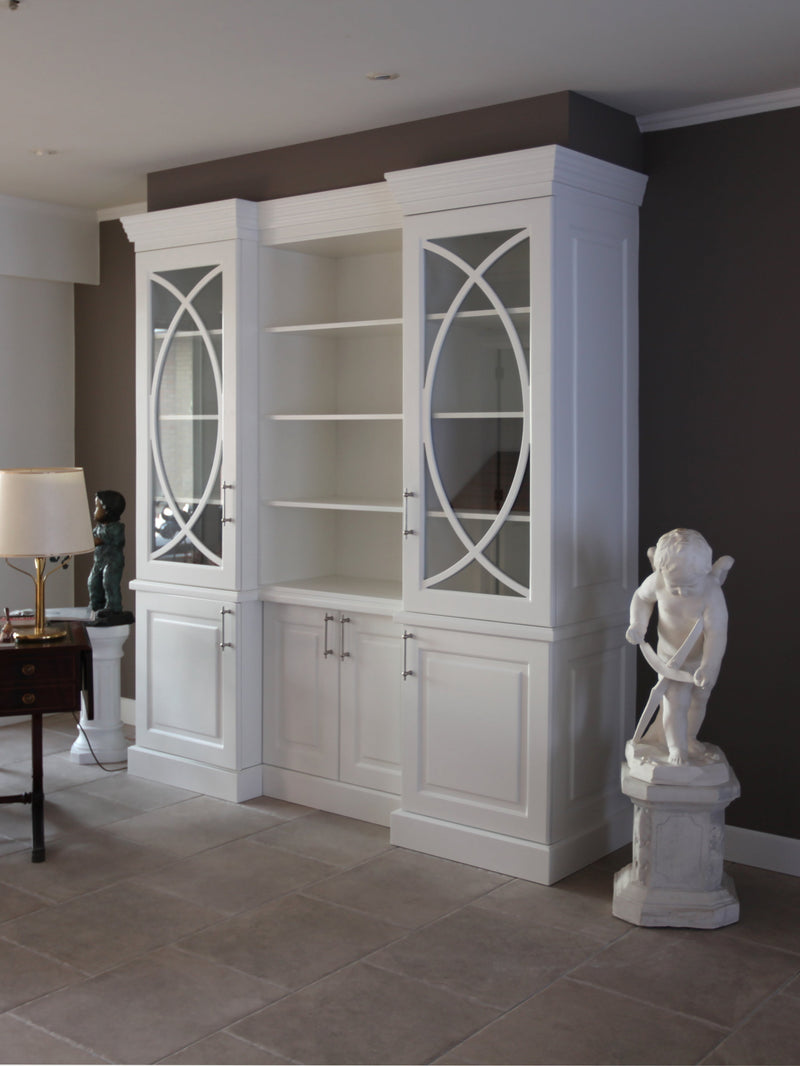 Decorative interior with white bookshelf, statue, and dark walls