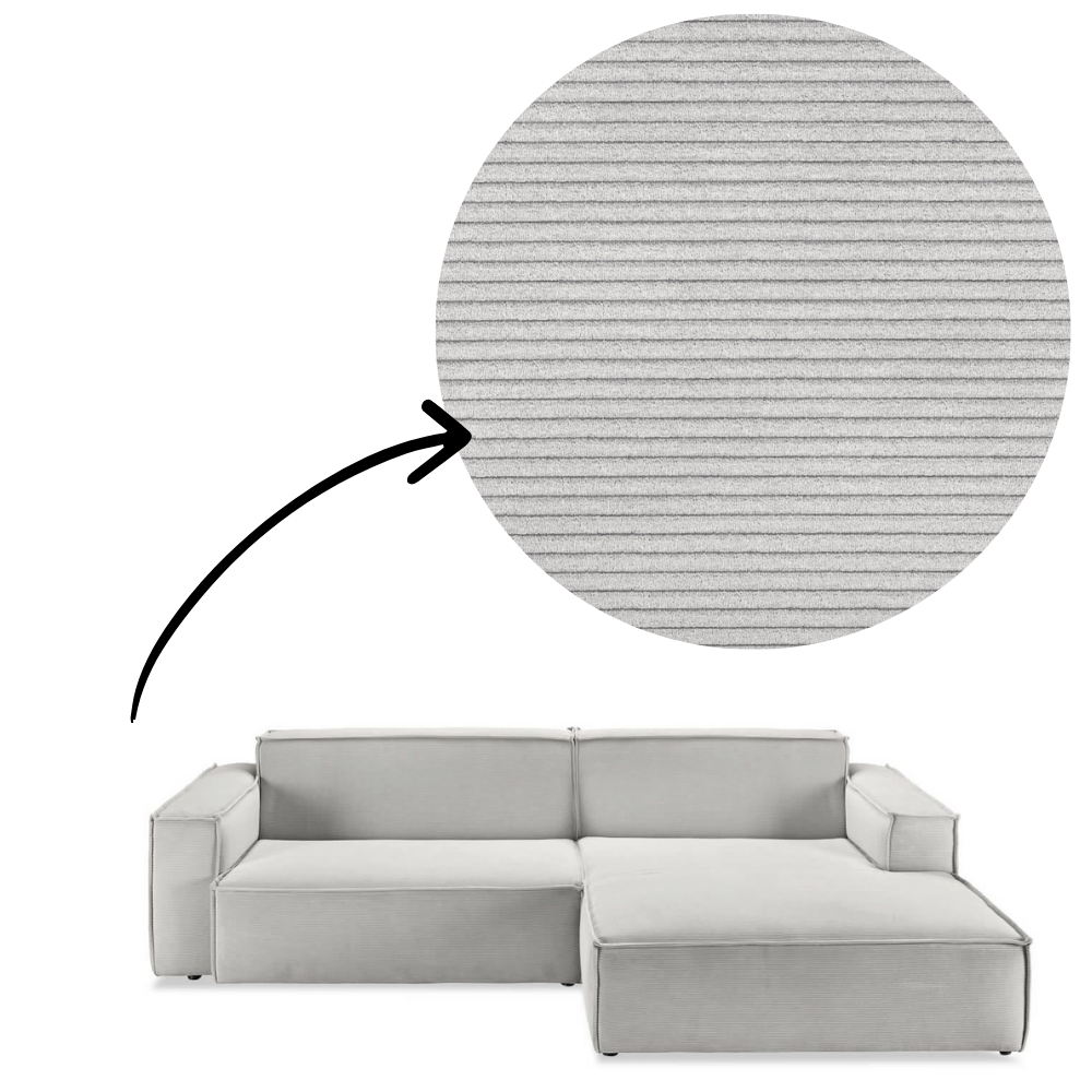 Sofa Midtown - Silber close-up of corduroy fabric texture mit arrow indicator, highlighting soft ribbed upholstery for tactile comfort.