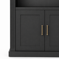 Close-up of black Arcade bookcase lower cabinet with shaker panel doors and brass pull handles