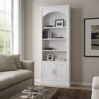 Classic white Arcade pine bookcase styled with books and frames in a bright living room