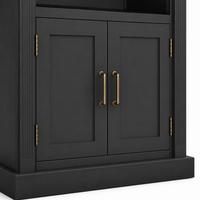 Close-up of black shaker cabinet doors on the Arcade bookcase with brass pull handles and hinges