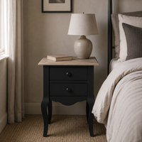 Cahors nightstand in black with oak top styled in a bedroom