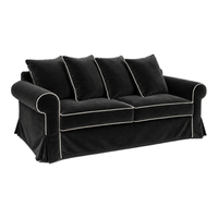 Castilliano country sofa in black velvet with white piping, three-quarter view