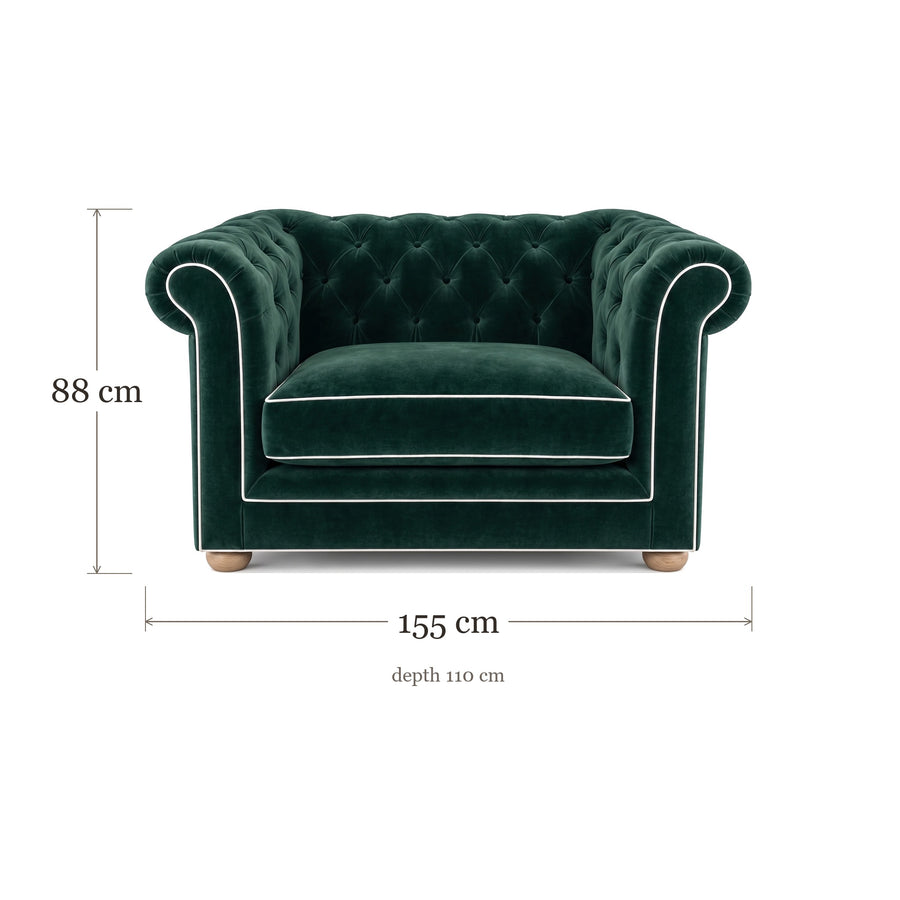 Chesterfield loveseat in forest green velvet with white piping, dimensions 155 x 110 x 88 cm