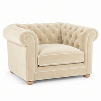 Chesterfield loveseat in cream velvet with white piping, three-quarter view