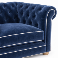 Chesterfield loveseat in navy blue velvet with white piping, velvet and piping detail