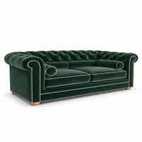 Chesterfield sofa in forest green velvet with white piping, three-quarter view
