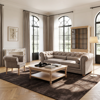 Chesterfield sofa in greige velvet with black piping in a classic living room