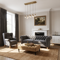 Chesterfield sofa in grey velvet with white piping in a classic living room