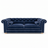 Chesterfield sofa in navy blue velvet with white piping, front view