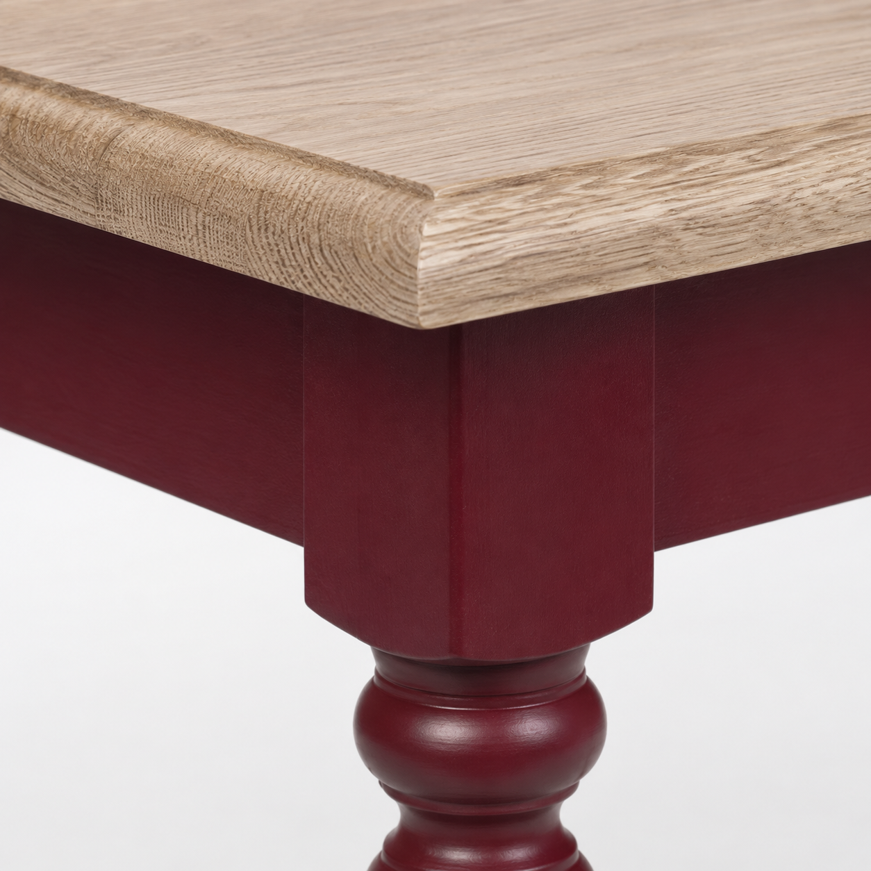 Close-up of the bordeaux finish and oak top detailing of the Pomerol coffee table