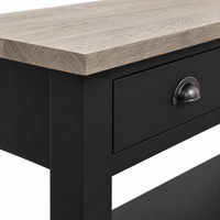 Close-up of the black finish, oak top edge and cup pull detailing of the Rully console table