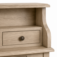 Close-up of the brass cup knob and oak grain on the classic Cheverny desk drawer