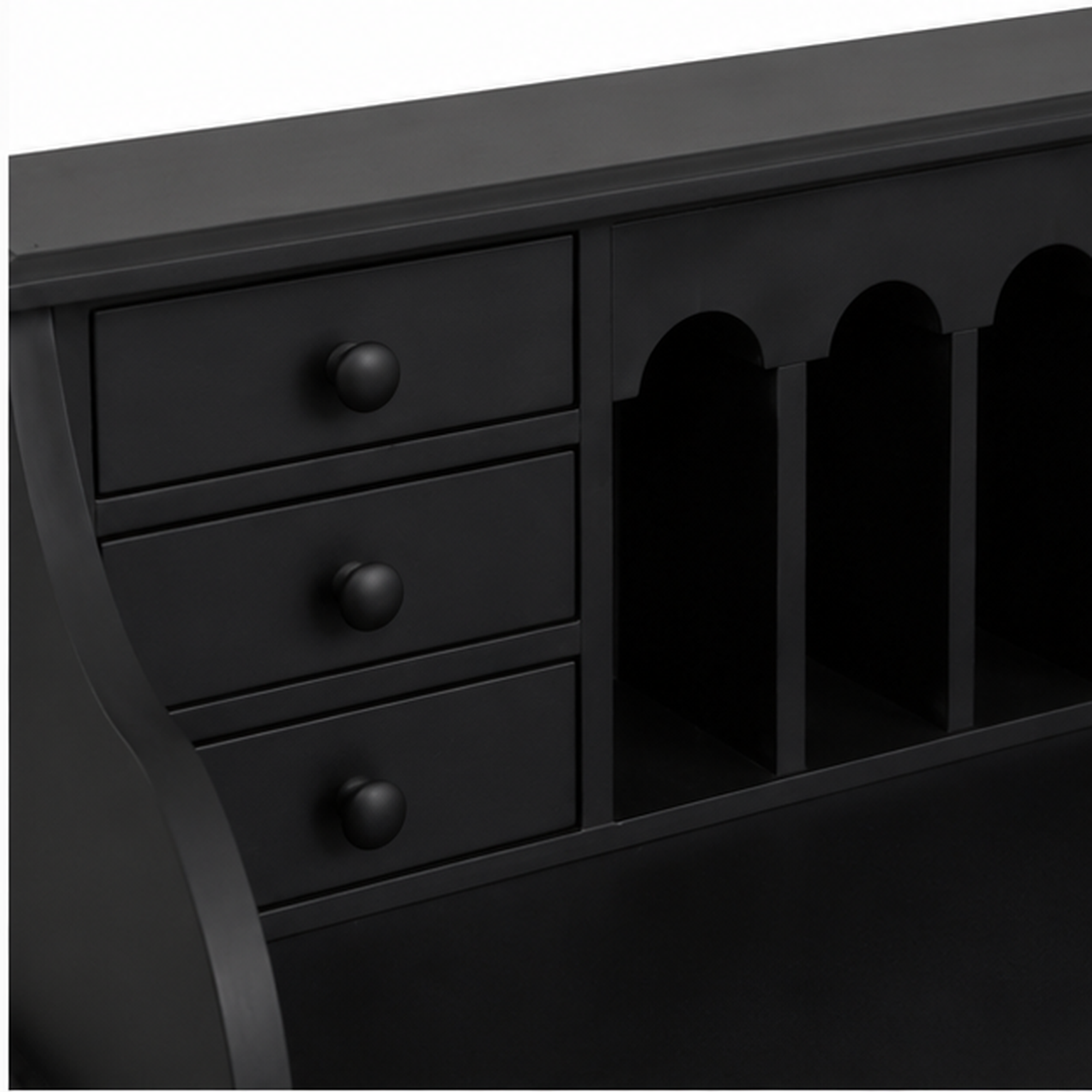 Close-up of the small drawers and arched pigeonholes on the classic black Dinan writing desk