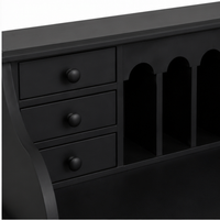 Close-up of the small drawers and arched pigeonholes on the classic black Dinan writing desk