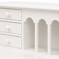 Close-up of the small drawers and arched pigeonholes on the classic white Dinan desk