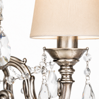 Hanglamp Gus 1088O macro detail showing intricate Antiek Zilver metalwork, crystal droplet accents, and woven fabric shade texture at high resolution, close-up material finish revealing brushed metal grain and decorative pattern by Marcottestyle
