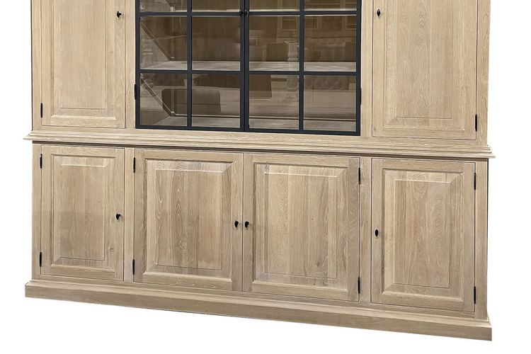 Raised-panel lower oak cabinet doors with black knobs of the Barton display cabinet