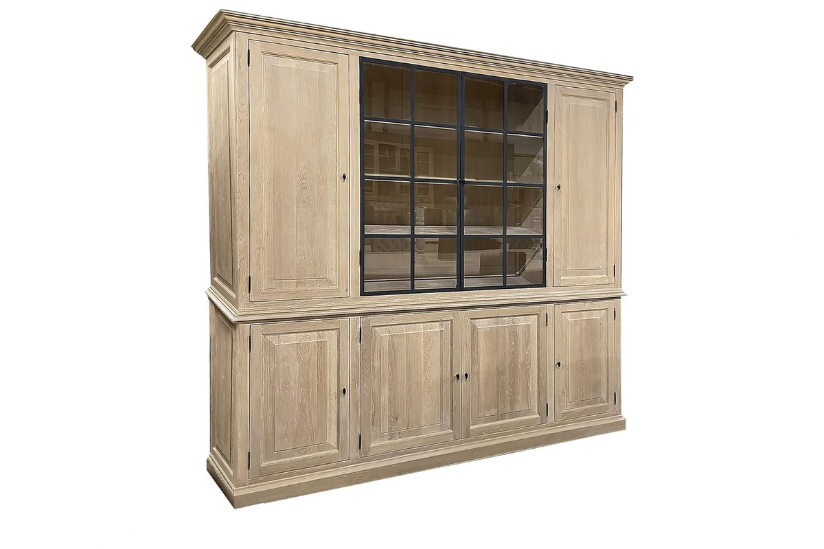 Solid oak Barton display cabinet at an angle, showing iron glazing and raised-panel doors
