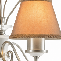Macro close-up detail of Kell 4910Q chandelier showing woven fabric texture of beige lampshade with braided trim, brushed ivory metal arm and crystal accents of the 3xE14 baroque pendant by Marcottestyle