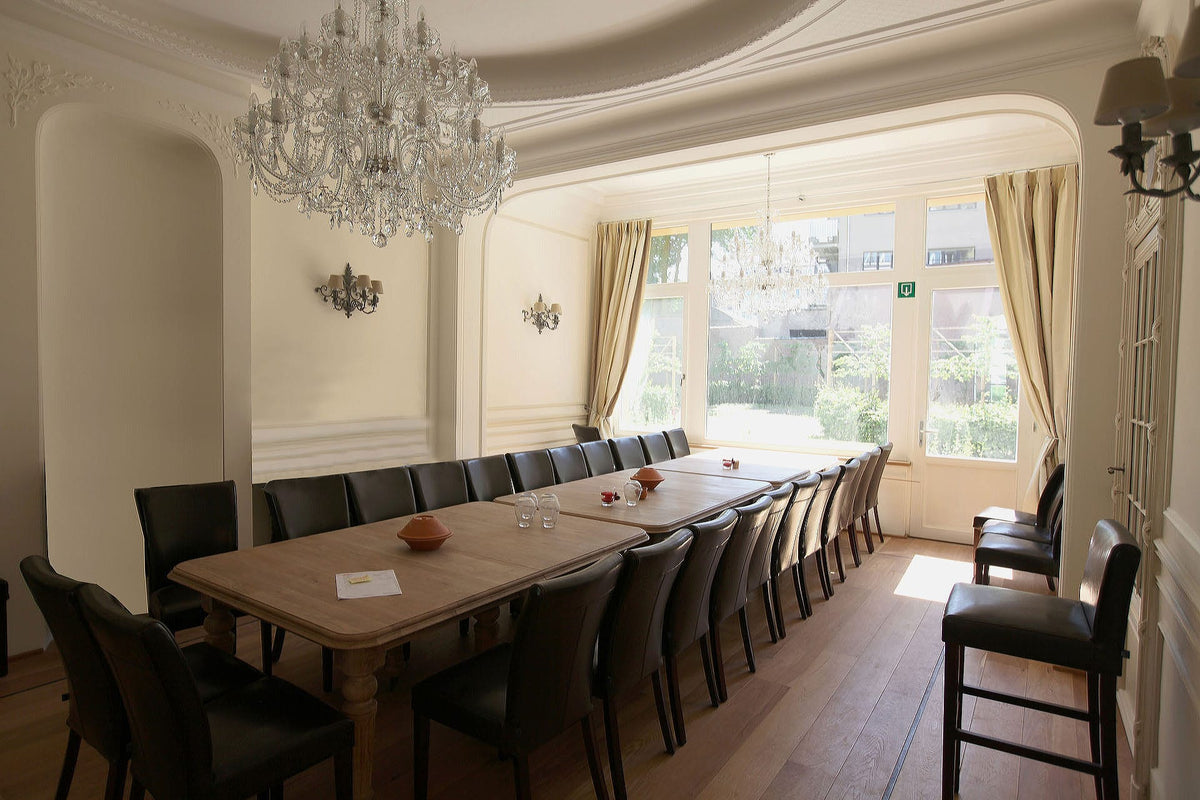 Long oak dining table under moulded plasterwork - Embassy, Brussels