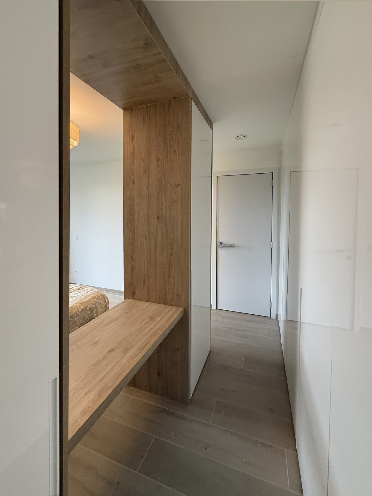 Full height mirror beside a floating oak shelf - Residence, Zonhoven
