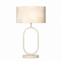 Tischlampe Merit 9026N Weiß mit lamp illuminated showing warm light glow through white fabric shade on white background professional product shot by Marcottestyle