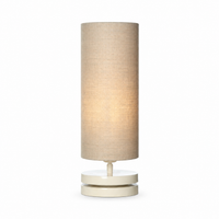 Lampe de table Mette 6176X Beige avec light turned on showing warm glow through fabric shade, front view on white background, elegant designer table lamp by Marcottestyle