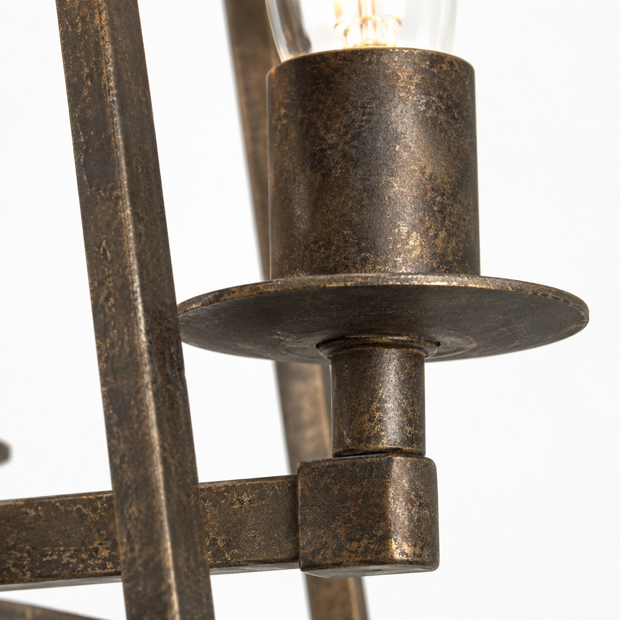 Macro close-up detail of Nina 8541D rust-finished metal candle holder showing aged patina texture, brushed-bronze grain and weathered surface of the 4xE27 trapezium pendant light by Marcottestyle