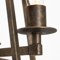 Macro close-up detail of Nina 8541D rust-finished metal candle holder showing aged patina texture, brushed-bronze grain and weathered surface of the 4xE27 trapezium pendant light by Marcottestyle