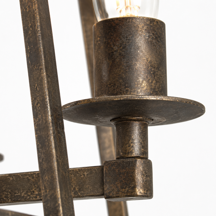 Macro close-up detail of Nina 8541D rust-finished metal candle holder showing aged patina texture, brushed-bronze grain and weathered surface of the 4xE27 trapezium pendant light by Marcottestyle