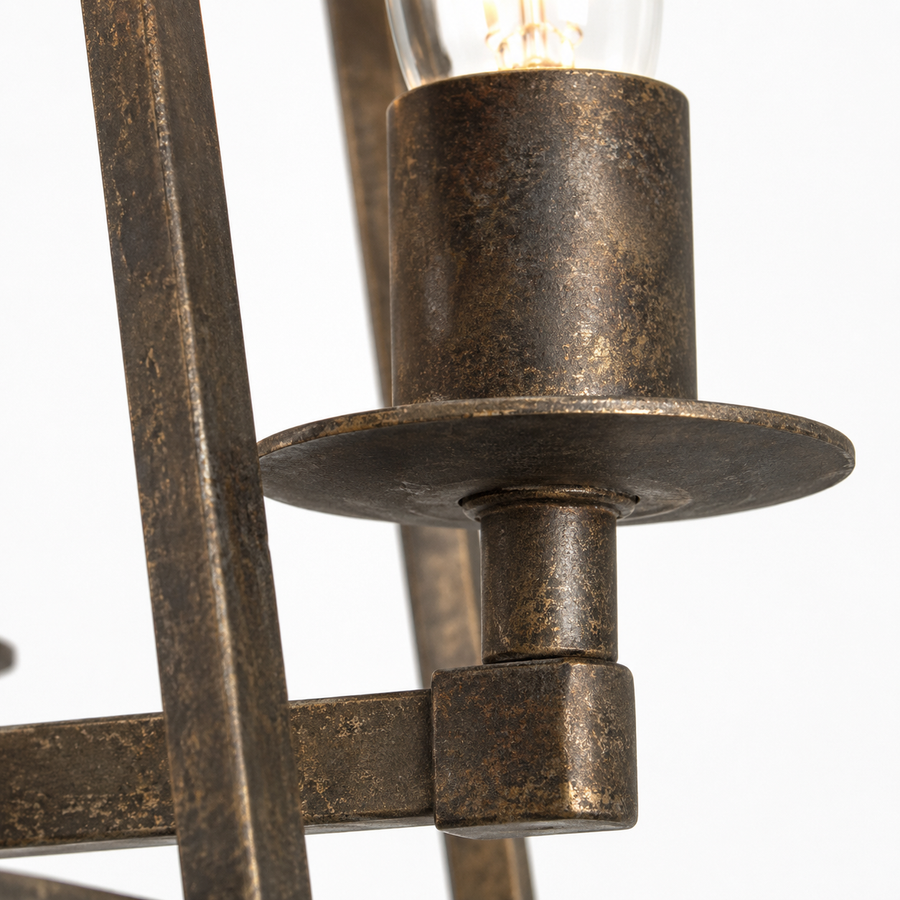 Macro close-up detail of Nina 8541D rust-finished metal candle holder showing aged patina texture, brushed-bronze grain and weathered surface of the 4xE27 trapezium pendant light by Marcottestyle