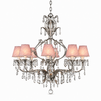 Hängelampe Gus 3680V mit lights on, antique silver chandelier glowing softly through pink fabric lampshades, studio product photography on white background by Marcottestyle